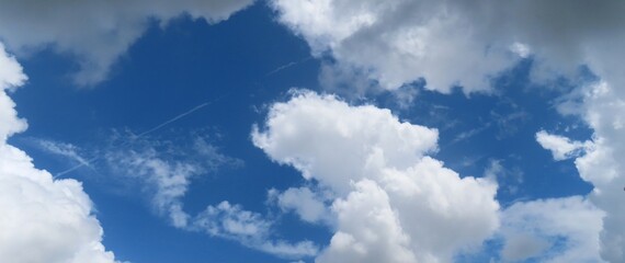 Wall Mural - panoramic view on beautiful cloudscape in blue sky