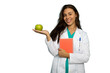 © PeopleVideos - Portrait of a young female doctor in a lab coat holding a green apple