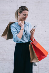 Wall Mural - cheerful female shopper making phone chat for contact service operator waiting for delivery, young s