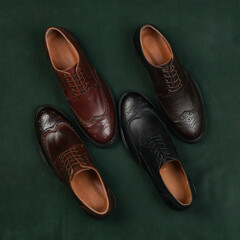 Four men's classic shoes made of brown leather on a colored background. Elegant fashion for a stylish man