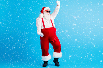 Wall Mural - Full length photo of cool funky overweight santa claus dance x-mas christmas newyear party club wear sunglass suspenders overall isolated over blue color background