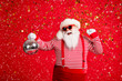 © deagreez - Photo of retired grandpa grey beard hold retro disco ball dance celebration wear santa x-mas costume suspenders sunglass gloves striped shirt cap isolated red color background