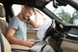 © New Africa - Injured man near opened airbag in automobile after car accident