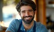 © Valentyna - A man with a beard and a blue apron is smiling at the camera