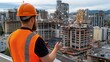 © lililia - A construction worker in an orange vest and helmet studies network visualizations on his tablet while overseeing a partially built city that merges tradition and modern tech