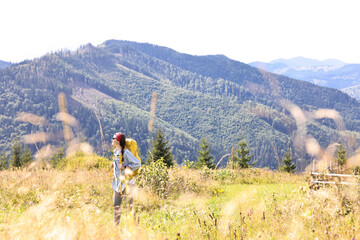 Poster - Young woman with backpack hiking in mountains