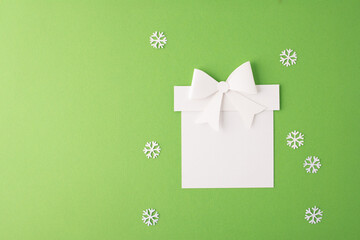 a festive craft project. paper cutout of a template gift box with a bow on top, DIY holiday decoration or greeting card project, Christmas spirit