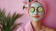 © Hound - A woman with cucumber slices on her eyes and a pink towel draped over her head. Concept of relaxation and self-care