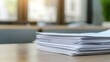 © DWN Media - A stack of papers on an office desk, representing the heavy effort and rigor to create medical marketing materials