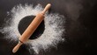 © adobedesigner - Rolling pin and white flour on a dark background. Free space for text.