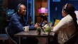 © DC Studio - African american influencer recording podcast with guest, using professional equipment in home studio. Joyful host discussing with woman live during broadcasting session for internet show