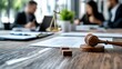 © Pinklife - In a detailed, focused discussion setting, a group of lawyers and officials examine documents with a gavel and scales symbolizing justice and decision amid deliberation.