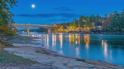 Wall Mural - A serene riverside scene at dusk with a bridge and moonlight reflecting on the water.