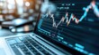 © Phirakhup - Close-up of laptop displaying financial chart with graphs and data analysis.