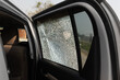 © toa555 - Cracked side car window glass on road . Damaged car window. .Car accident claims via insurance apps.