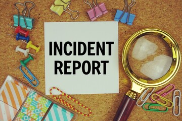 Wall Mural - incident report text on paper card with magnifying glass and stationery on cork board background
