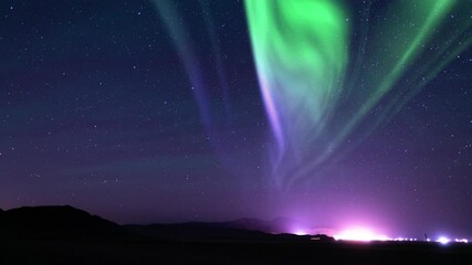 Wall Mural - night skies unveiled aurora and milky way above mountains town loop