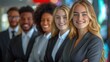 © Robert Anto - A diverse group of business professionals in formal attire, standing together and smiling, representing teamwork and corporate culture