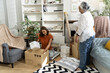 © pixs4u - Young Asian woman and mother Packing Moving Boxes in Cozy Living Room