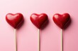 © Sergey - Trio of candy hearts on pink background symbolizing love sweetness