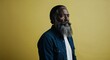 © sevenSkies - Middle aged Black man with long beard focused pale yellow background