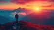 © Alienmarsh - A lone hiker stands on a mountain peak, watching the sunrise over a stunning mountain range.