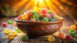 © PloyJai - A bowl filled with brightly colored, translucent candies, arranged in a haphazard manner, on a wooden surface bathed in warm, golden light.