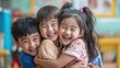 © thesweetsheep - Joyful Asian Children Hugging in Classroom After Successful Group Project, Expressing Happiness and Unity