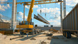 © Kosin - Construction site with crane lifting steel beams, surrounded by machinery and materials. bright sky adds dynamic feel to busy environment