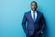© Lazy_Bear - Portrait of confident black man wearing blue suit and light shirt standing against vibrant blue background