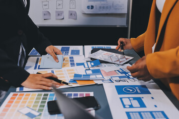 Wall Mural - the designer team is designing the uxui system to make the uxui system work well on new phones and s