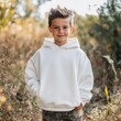 © Alena - Kids white hoodie mockup. Standing handsome boy model in Gildan 18500, autumn nature background. Kids long sleeve tshirt mockup. Halloween, Thanksgiving, fall holidays basic blank shirt template