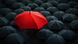 © Elshad Karimov - A lone red umbrella stands tall, providing shelter against a sea of dark umbrellas below. This striking visual represents the concept of leadership, where one individual stands out