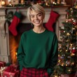 © Alena - Women green sweatshirt mockup. Young female model in long sleeve tshirt, rich decorated indoor interior, fireplace with Xmas gifts, Christmas tree. Women's Gildan 18000. Basic pullover, winter jumper