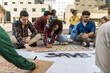© Lomb - Diverse student activists prepare protest signs: youth engagement in social change
