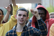 © Lomb - Diverse youth activists raise fists in solidarity: multicultural protest for social change