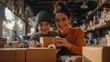 © Oulaphone - A joyful woman and child are surrounded by shipping boxes, smiling and engaging in packing activities in a cozy workspace.