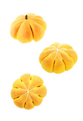 Sticker - Pumpkin shaped buns in air on white background