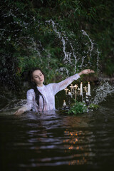 Wall Mural - A girl dancing in the river in splashes of water