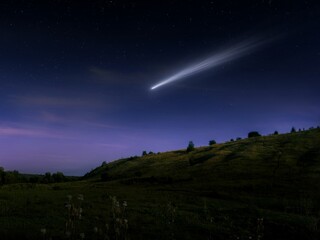 comet in the sky of the earth. night landscape with a glowing comet tail. shooting star, large celes