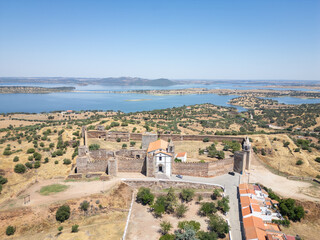 Aerial view of village and castle Mourao, district Evora,  Portugal, with Alqueva Dam behind