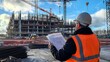 © authapol - Engineer in High Visibility Jacket at Construction Site