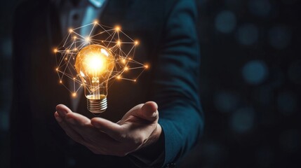 Aufkleber - A glowing light bulb held in a hand symbolizes creativity, innovation, and bright ideas against a dark backdrop.
