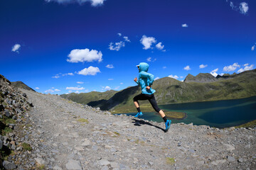 Poster - Fitness woman runner running at beautiful mountain top