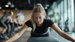 © fotofabrika - Fitness enthusiast practicing a stretching exercise on a mat in a modern gym during a small group training session