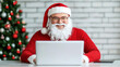 © Piya W. - Confident young businessman Santa Claus working in online store for business Small business owner at his desk online shop christmas sale SME and dropshipping