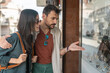 © Srdjan - Young beautiful happy couple in love looking for engagement or wedding ring through the street glass window of jewelry store.