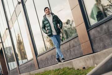 Poster - Photo of nice attractive man dressed trendy clothes walking city center cold spring day outdoors