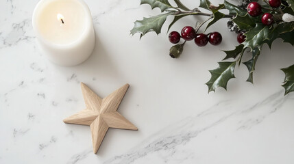 Minimalist Christmas decoration with a white candle, wooden star, and holly with red berries on a marble surface