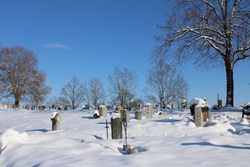 snowy graveyard on a beautyful sunny winterday